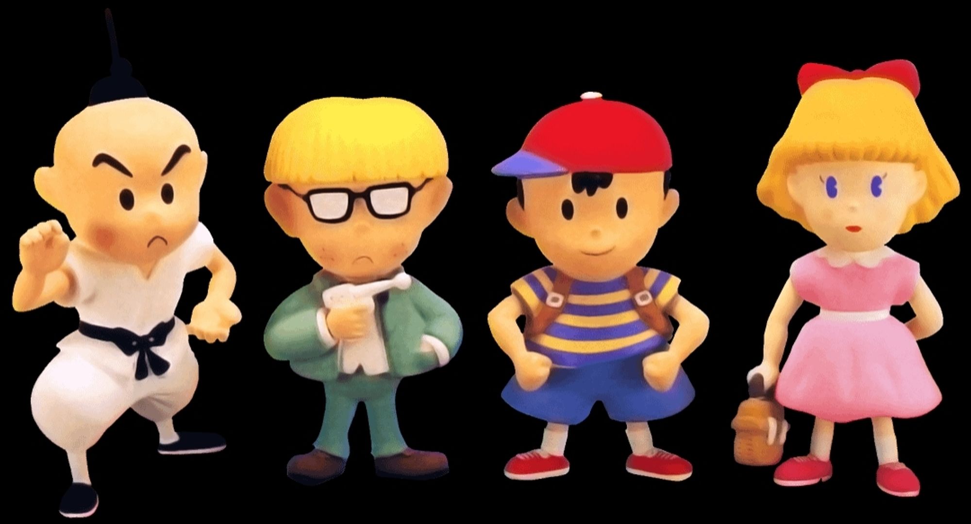 Four clay figures of three boys and a girl. They are the playable characters from Earthbound