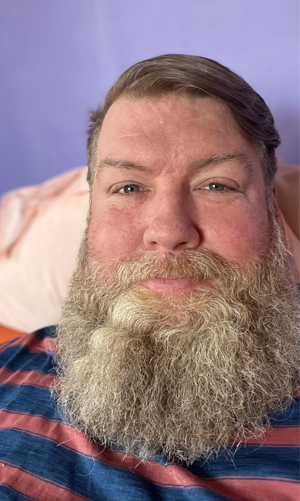 The account holder — white, bearded and 47 — sitting up in bed