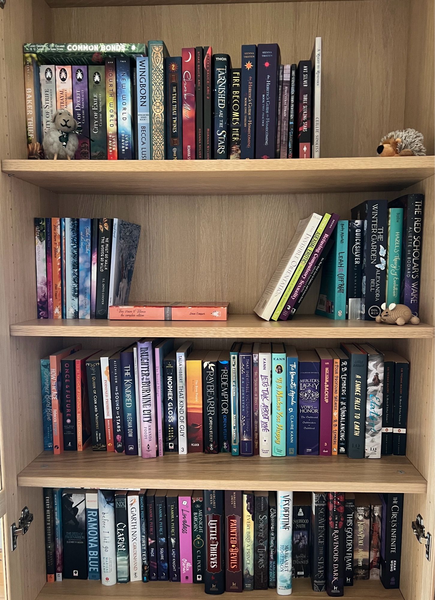 Four shelves full of books with aspec rep. There’s, like, 80 books or so in total? It’s however many fit on four shelves.