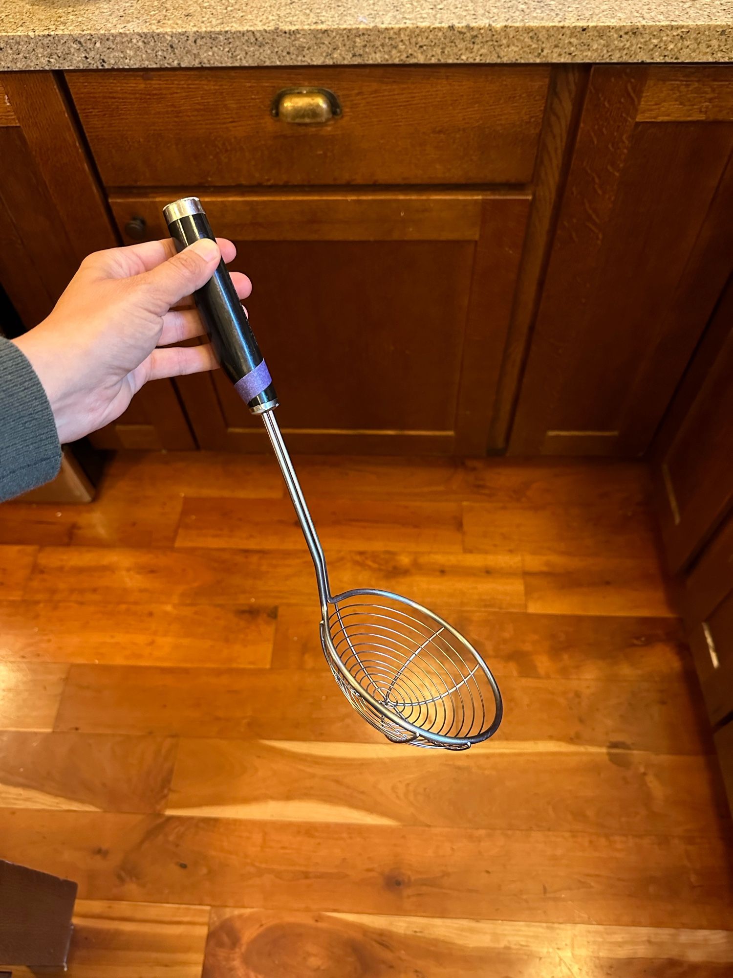 My hand holding a kitchenaid wire spider