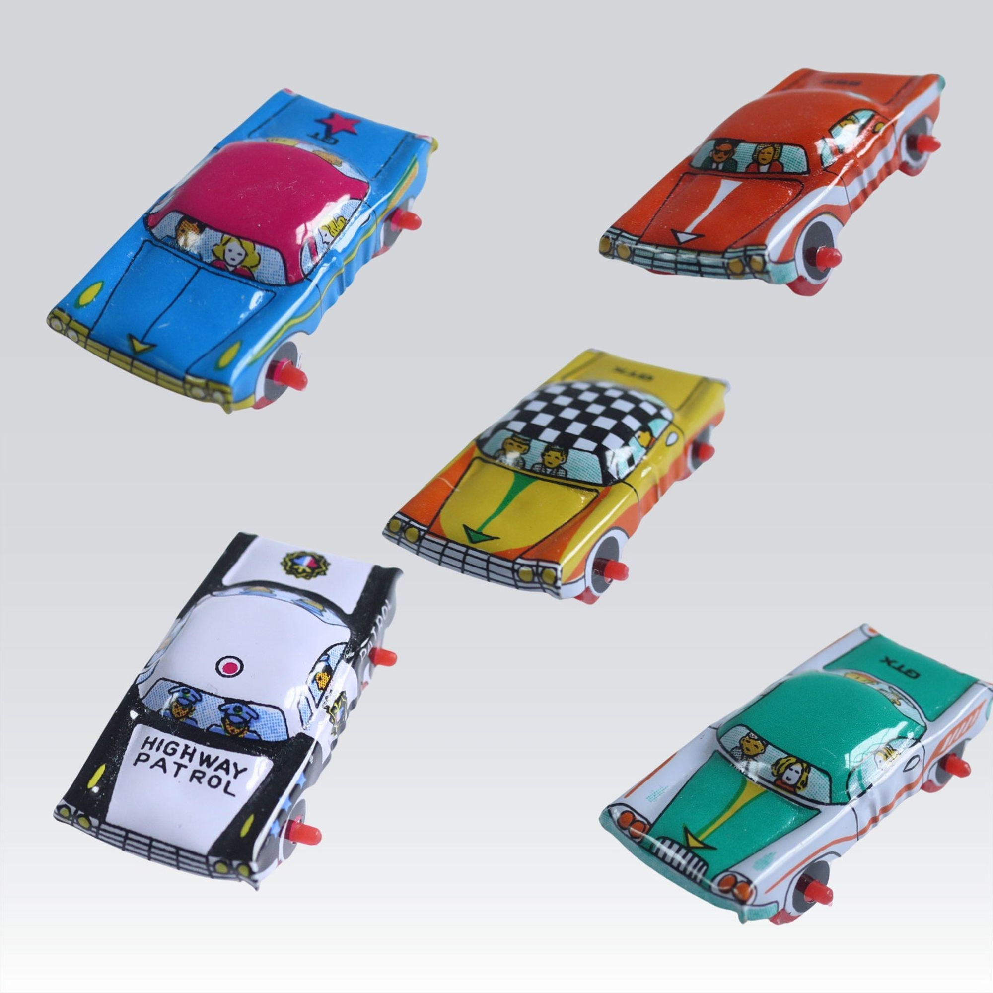 miniature 1950s lithograph tin cars in different patterns including a green sedan, black and white police car, yellow checker ca, blue sedan https://swirlingorange11.com