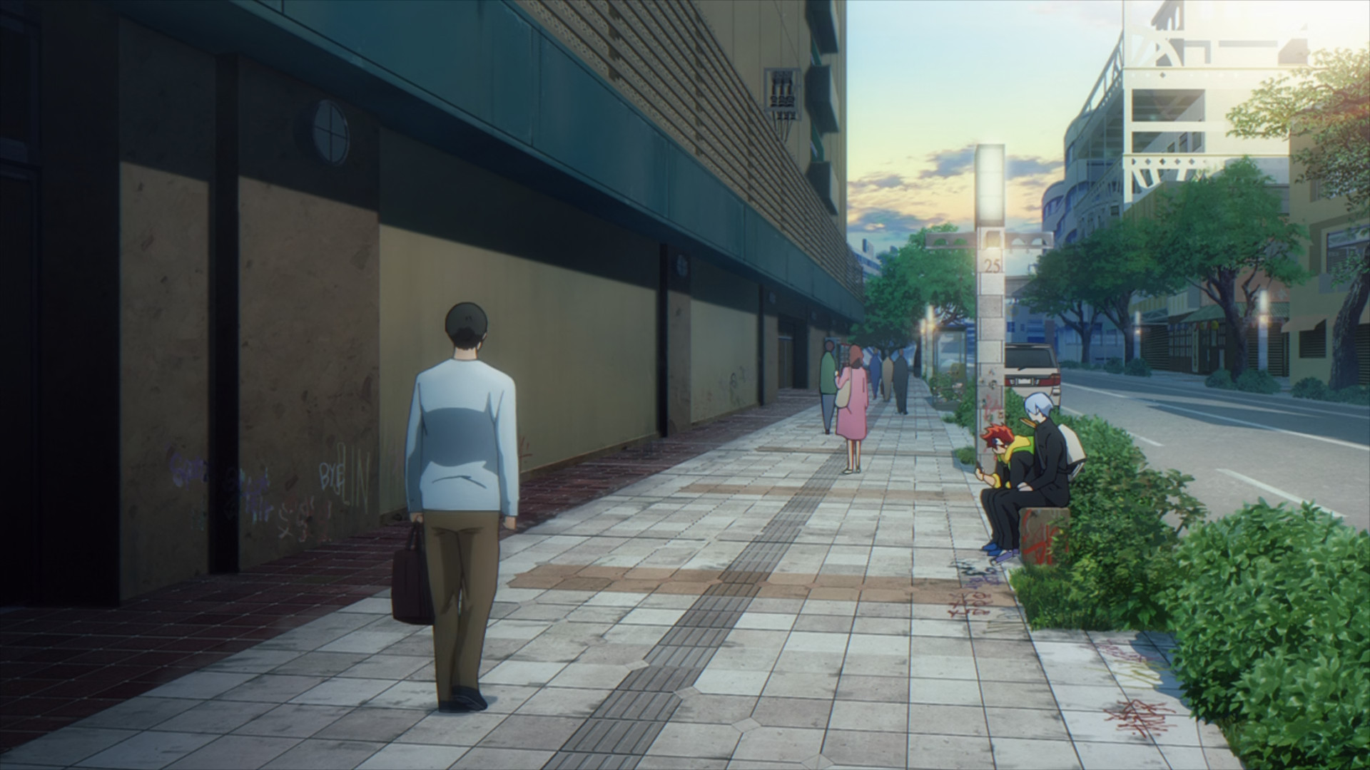 Reki and Langa sitting on a bench by a busy sidewalk