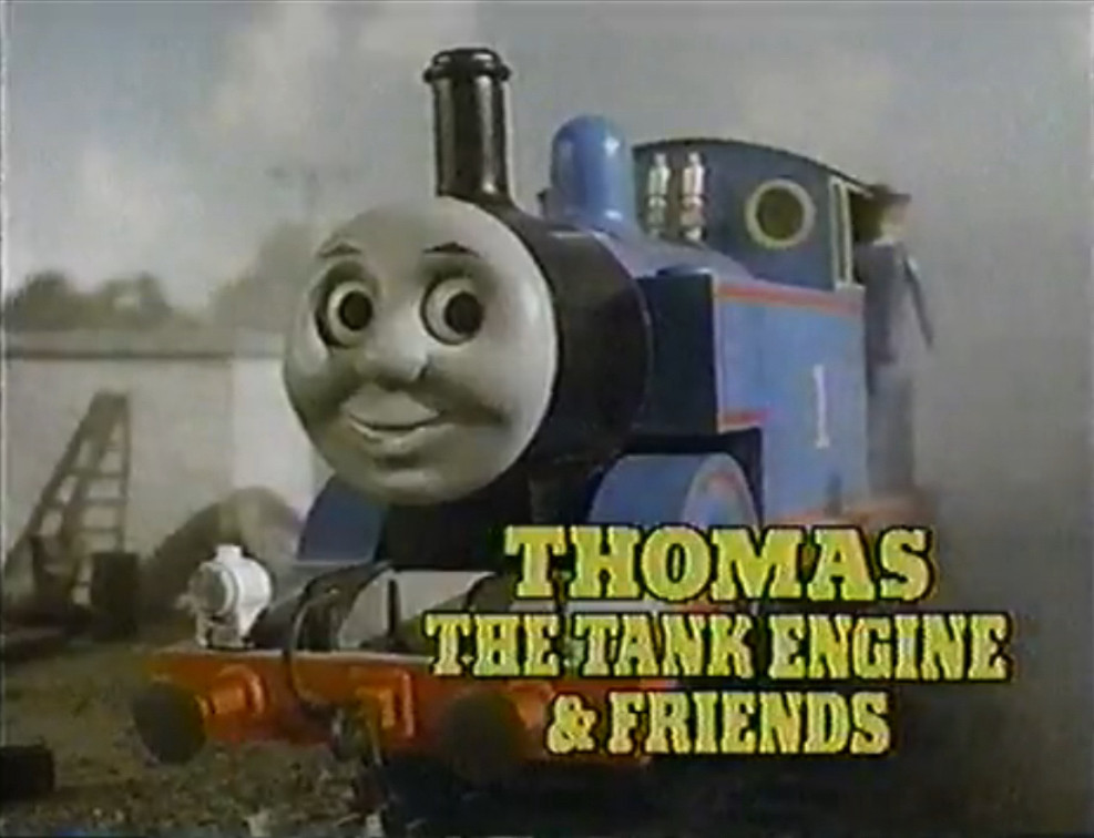 Thomas the Tank Engine & Friends title screen with uncanny valley face on a blue and red train in a scene that’s weirdly gray for a children’s show???