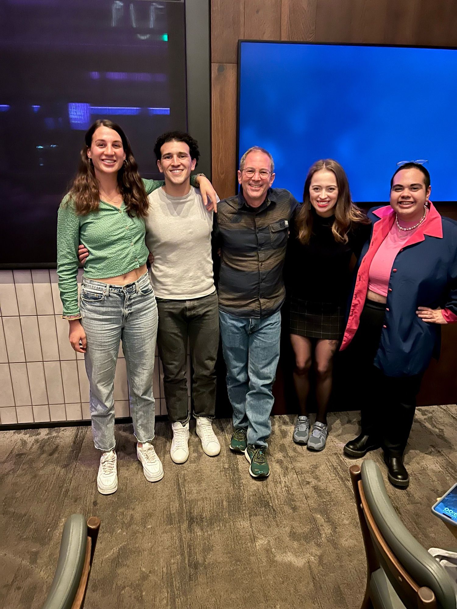 Five adults standing and smiling. 4 alumni of the BP-Endure summer program and the director, Dr. Erik Herzog.