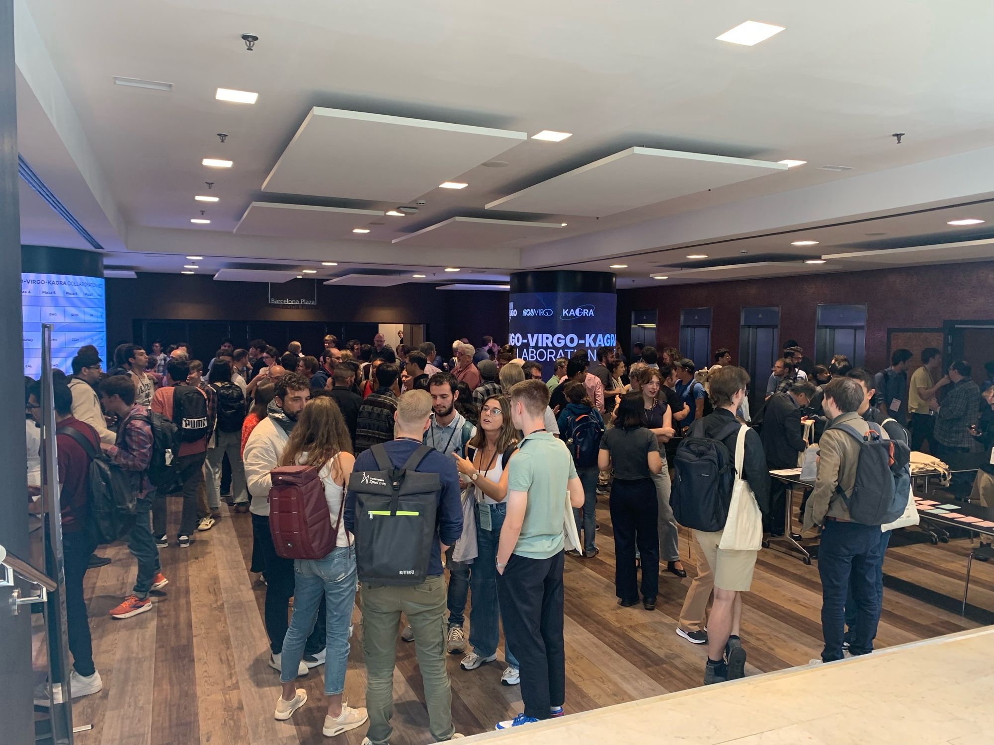 A foyer filled with people mingling during a coffee break.