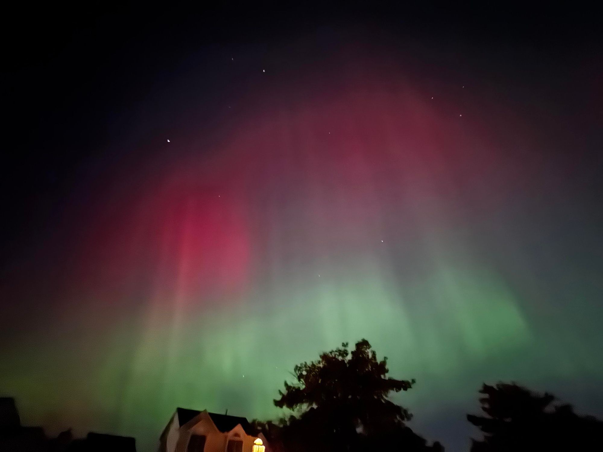 The aurora borealis over a neighborhood