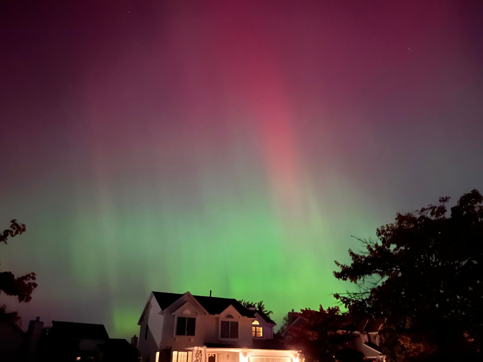 The aurora borealis over a neighborhood