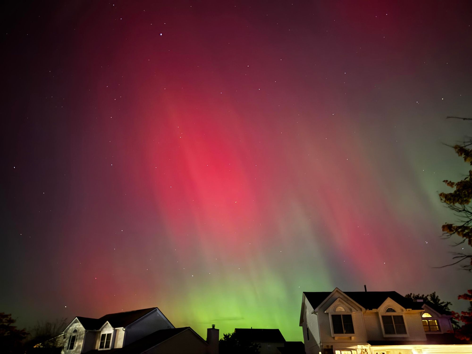 The aurora borealis over a neighborhood