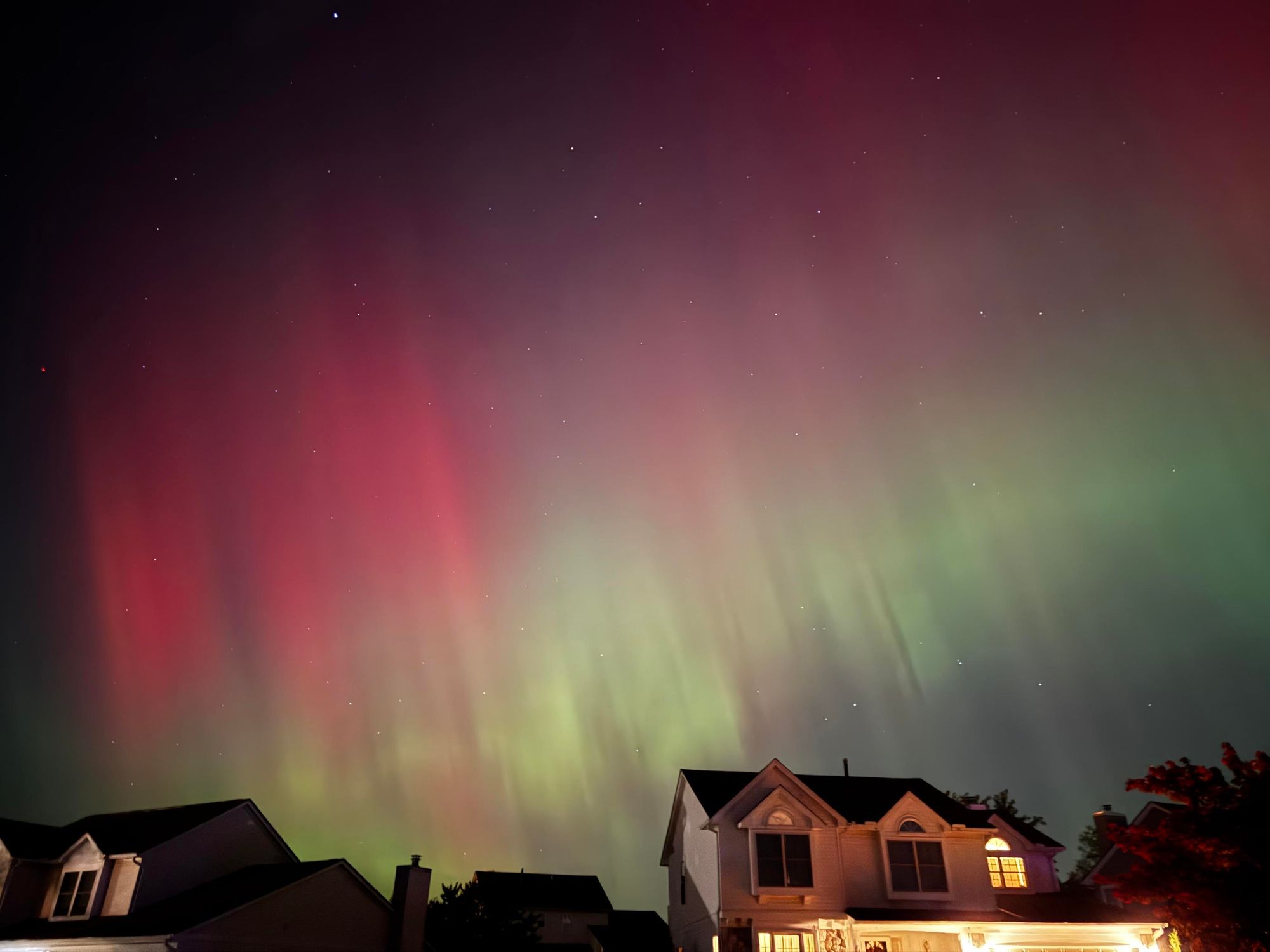 The aurora borealis over a neighborhood