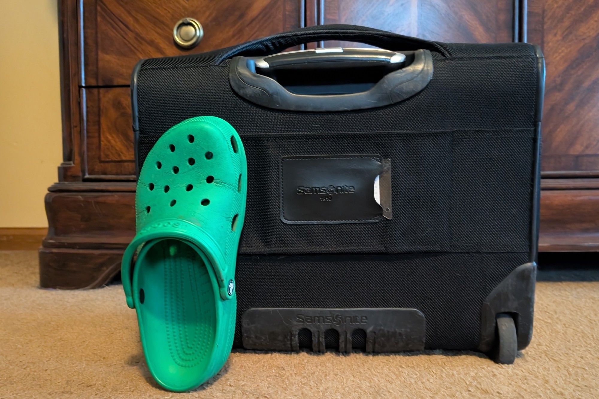 My carry-on luggage, with size 8.5M/10F Croc for scale. It's pretty small.