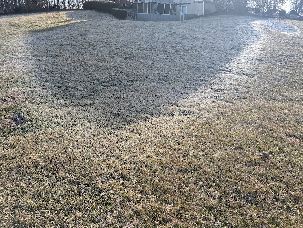 The shadow of my house in the yard, outlined by frost.