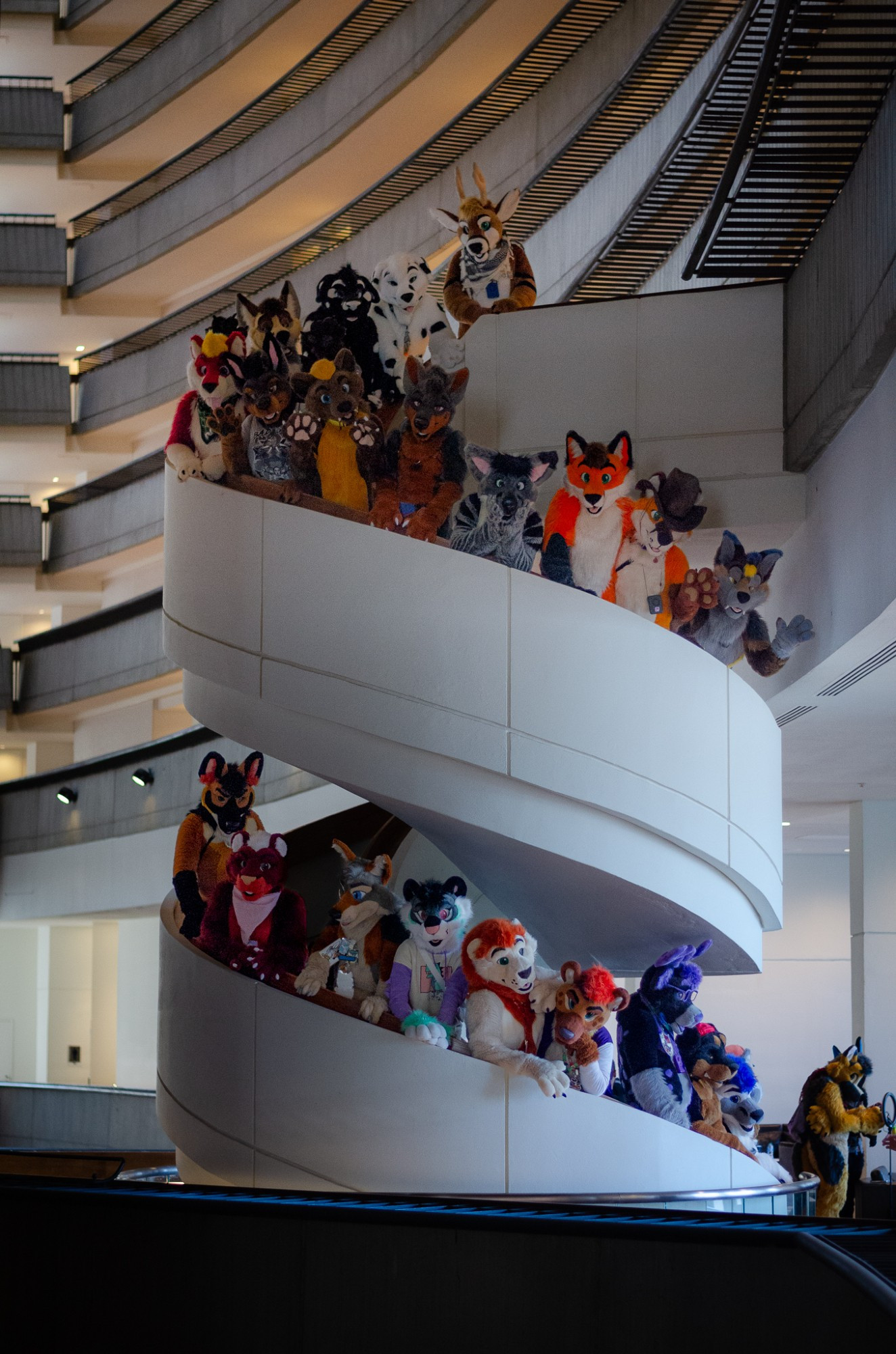 A fursuit group photo on a spiral staircase