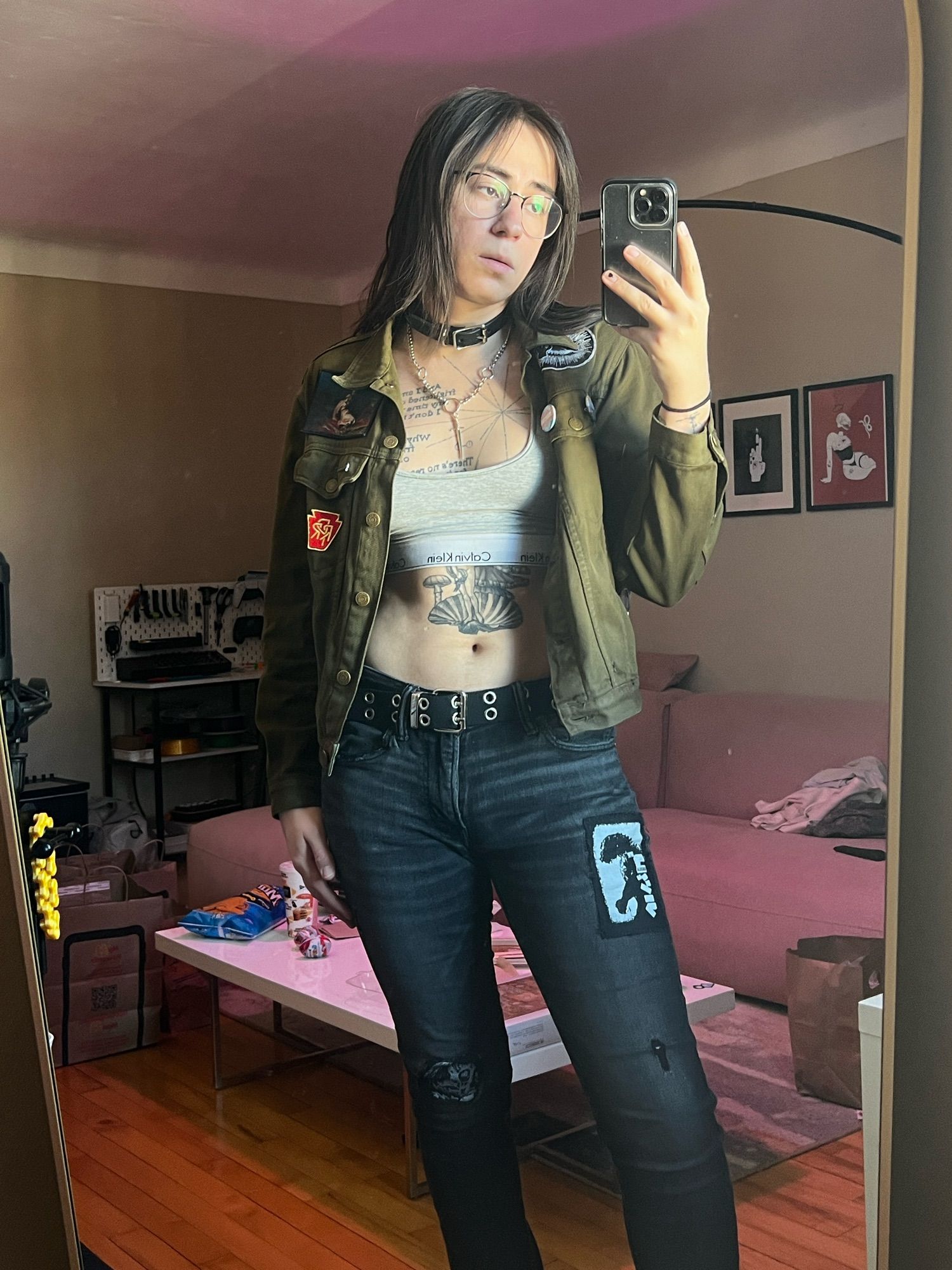 lex in a bralette, jacket, and jeans