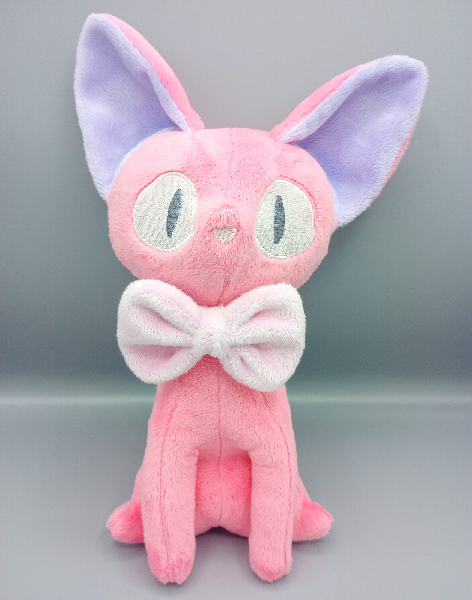 A handmade pink Jiji plushie from the Studio Ghibli movie Kiki's Delivery Service.