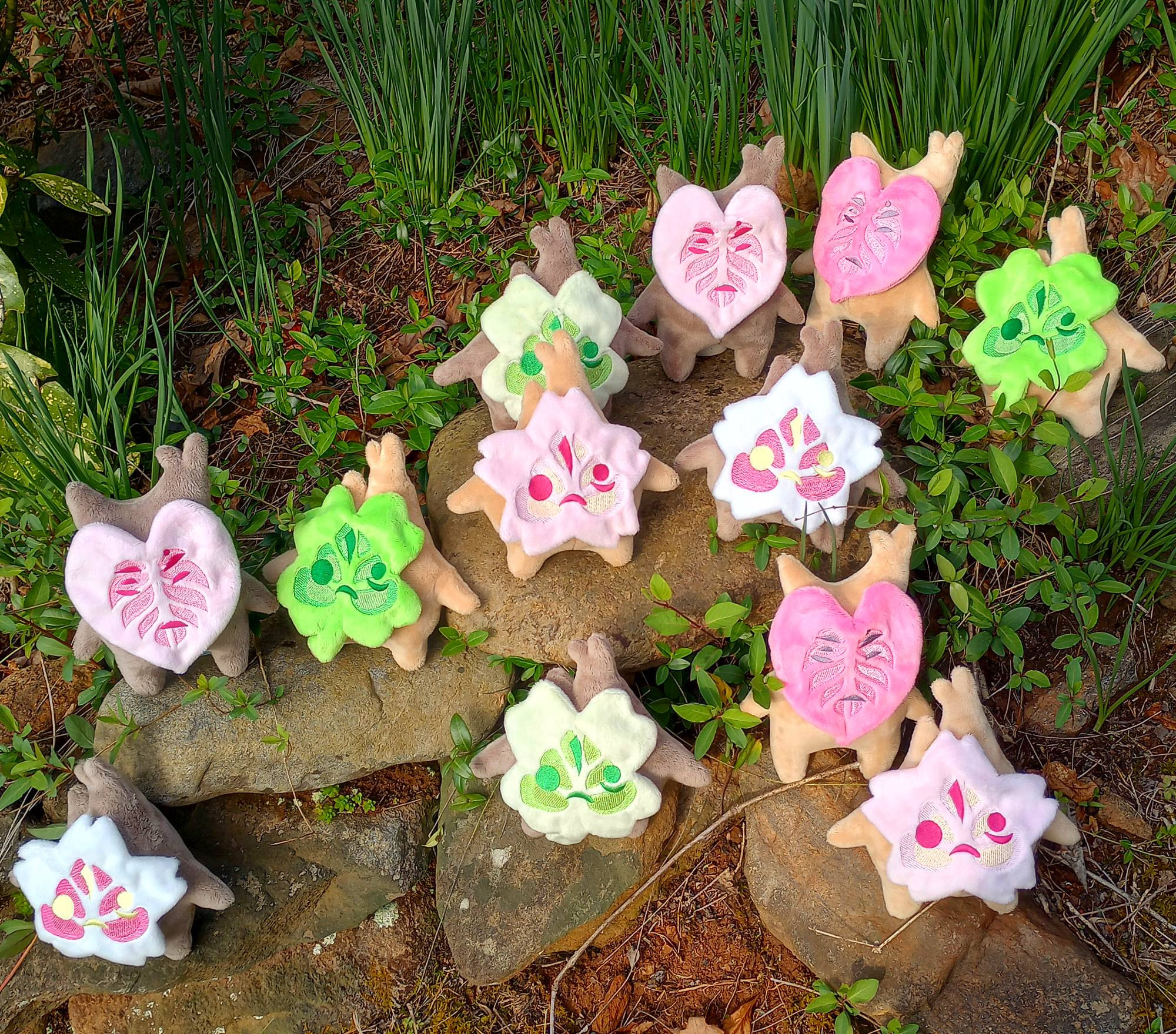 A collection of handmade Spring-themed Korok plushies from the Legend of Zelda.