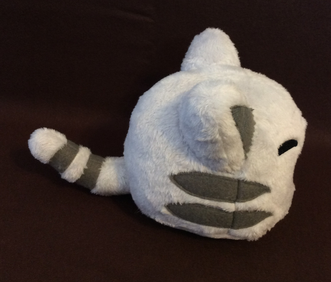 The side of my handmade Tabby Slime plushie.  The angle shows the stripes and tail better.