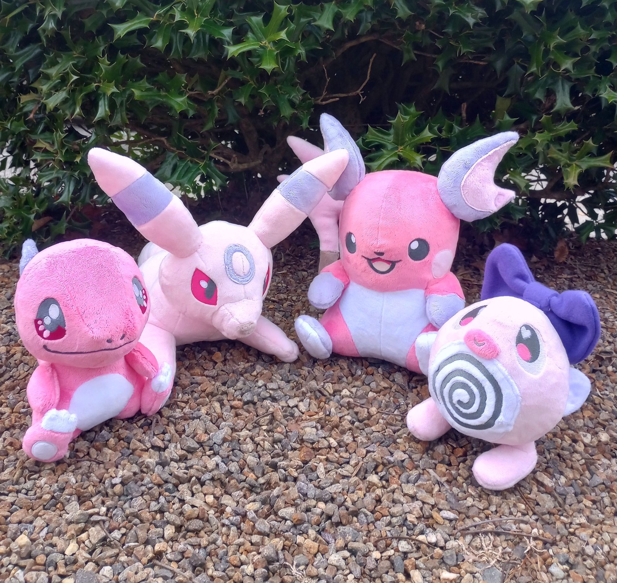 A collection of handmade pink Pokemon plushies.