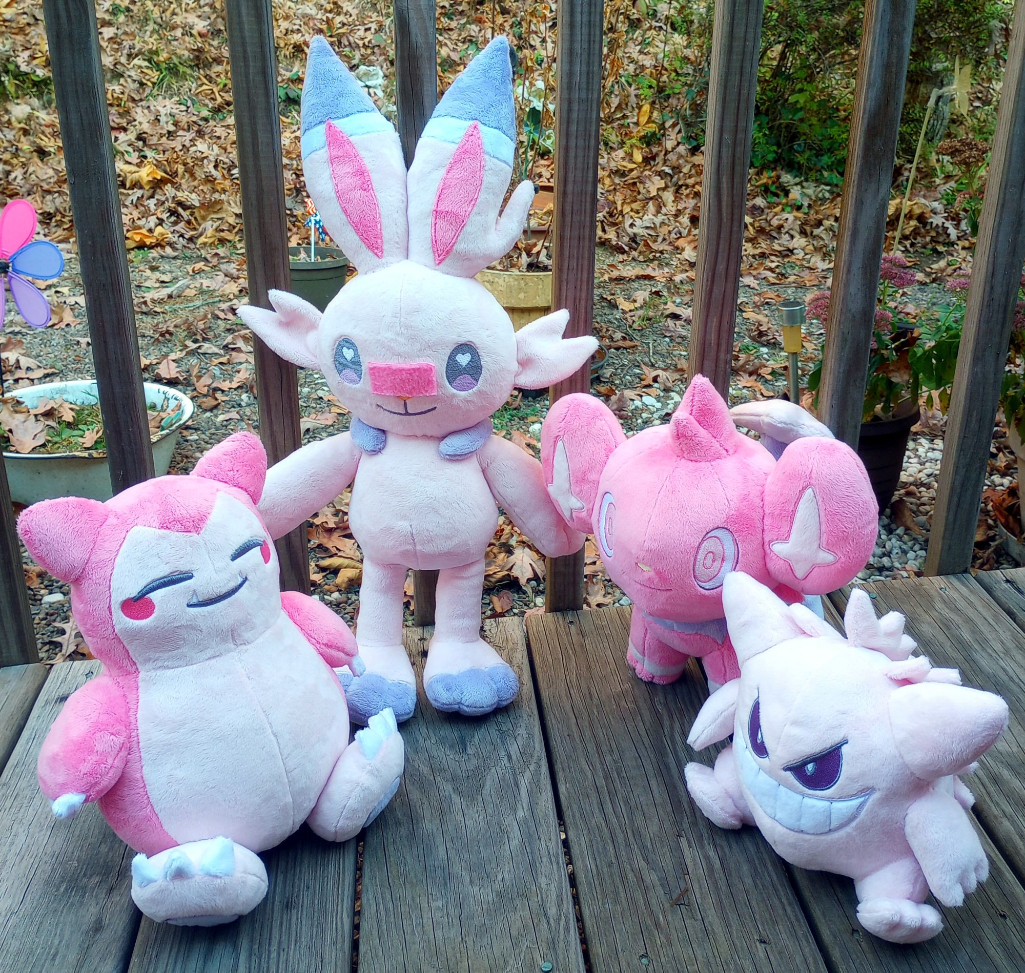 A collection of handmade pink Pokemon plushies.