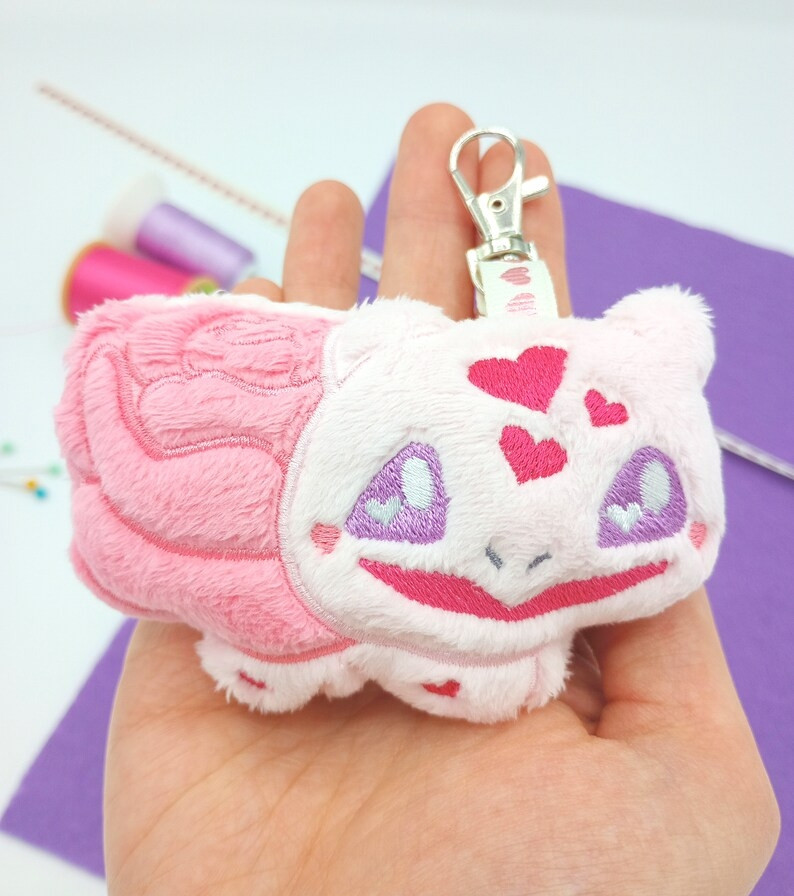 A handmade pink Rose Bulbasaur plushie keychain from Pokemon.