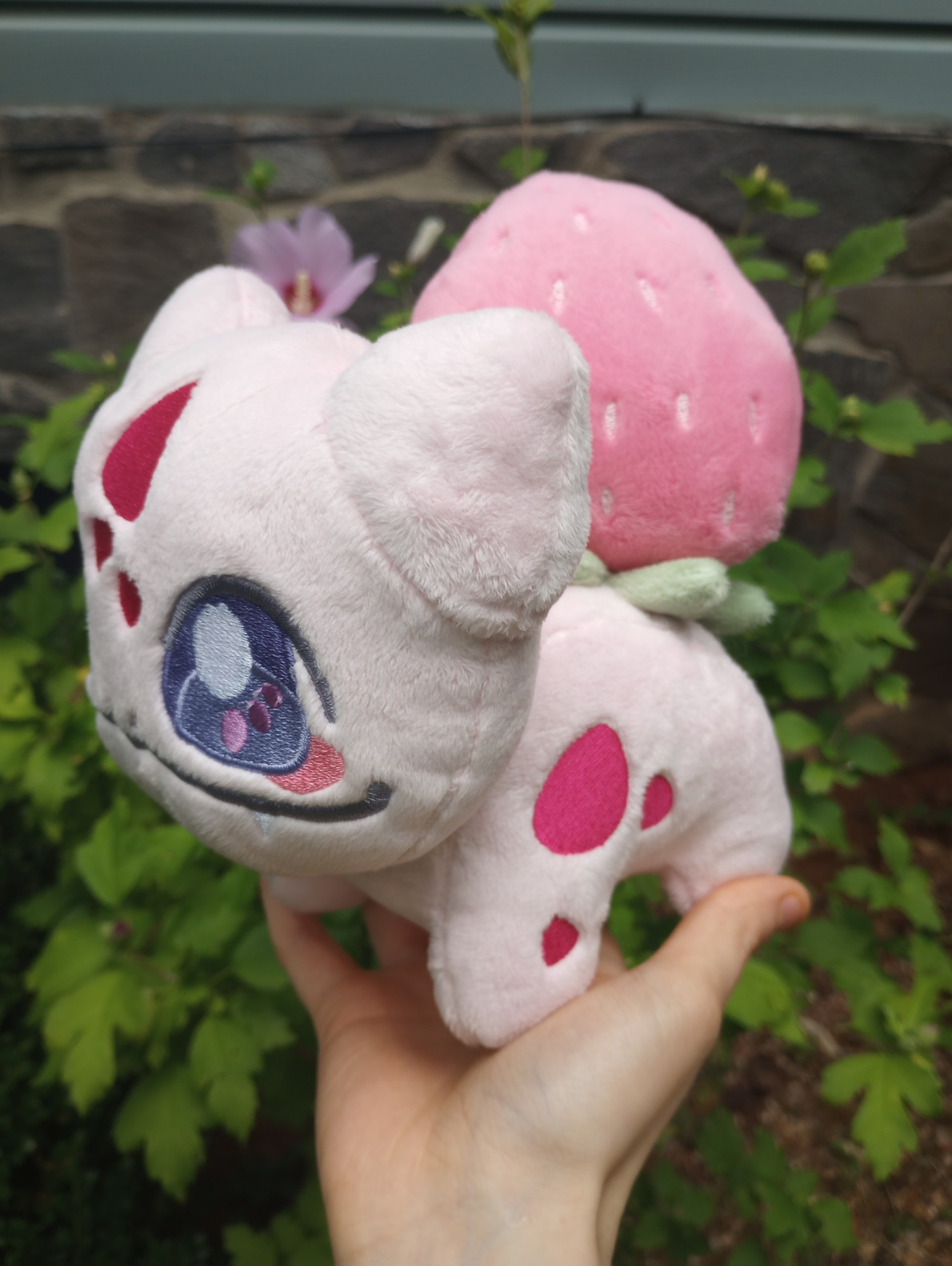 A handmade pink Strawberry Bulbasaur plushie from Pokemon.