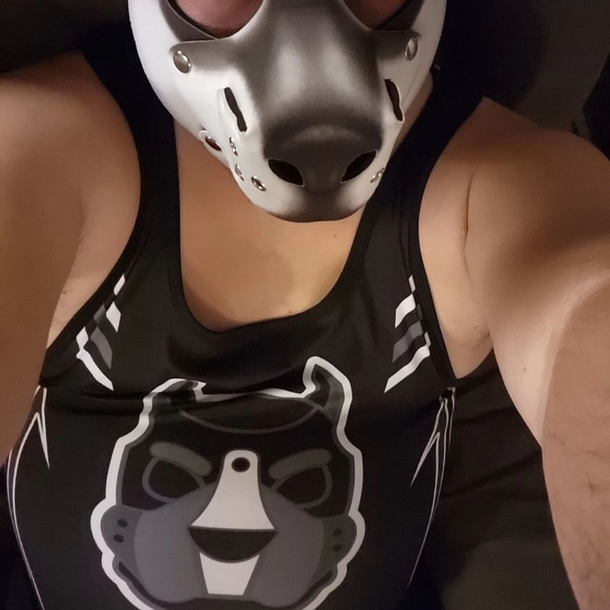 A selfie showing off the CellBlock13 singlet with a pup hood design on the front. Part of a GrungeBunny pup hood is seen.