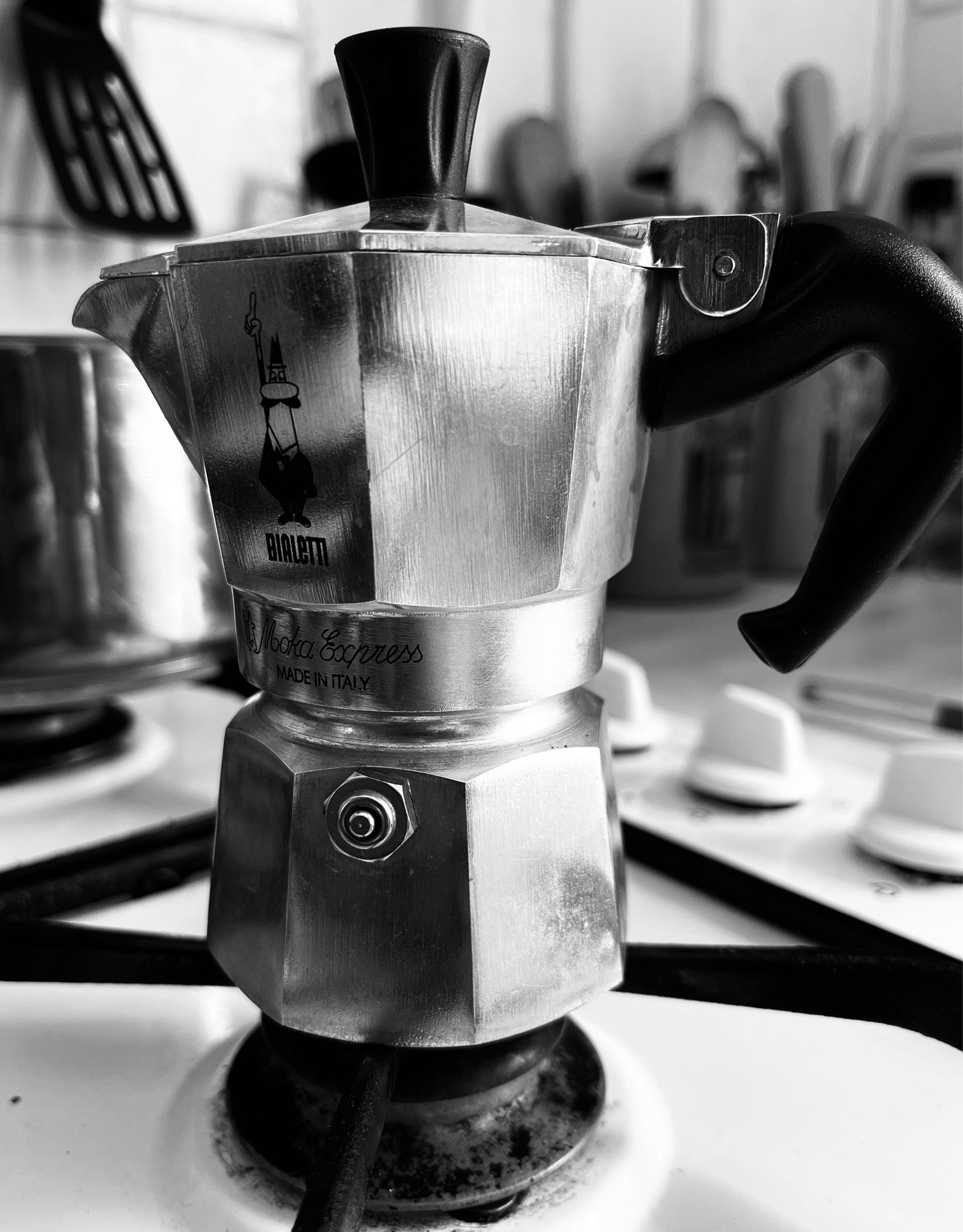 B&W shot of a trusty Bialetti moka pot on a hob