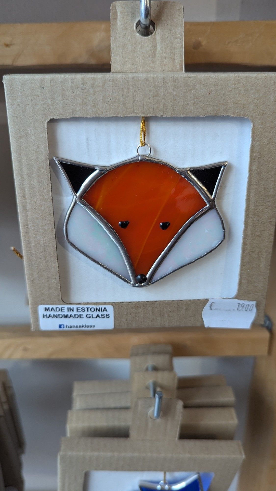 A glass coaster in the shape of a fox face from a shop in Tartu