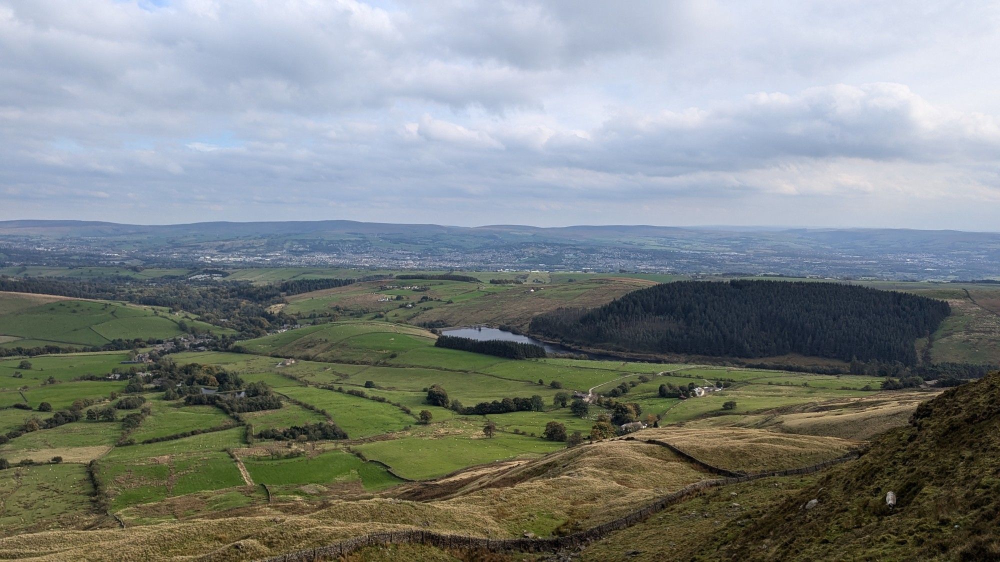 The view of Lancashire from near the summit, with Black Moss Reservoir visible in the centre