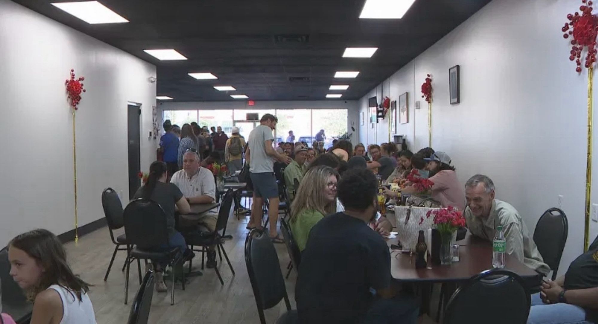 Patrons seated inside a crowded restaurant