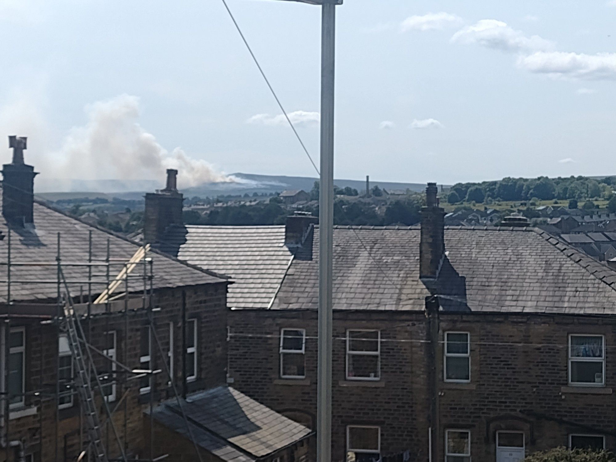 The moors above Meltham. A huge area is on fire, smoke filling the valley below