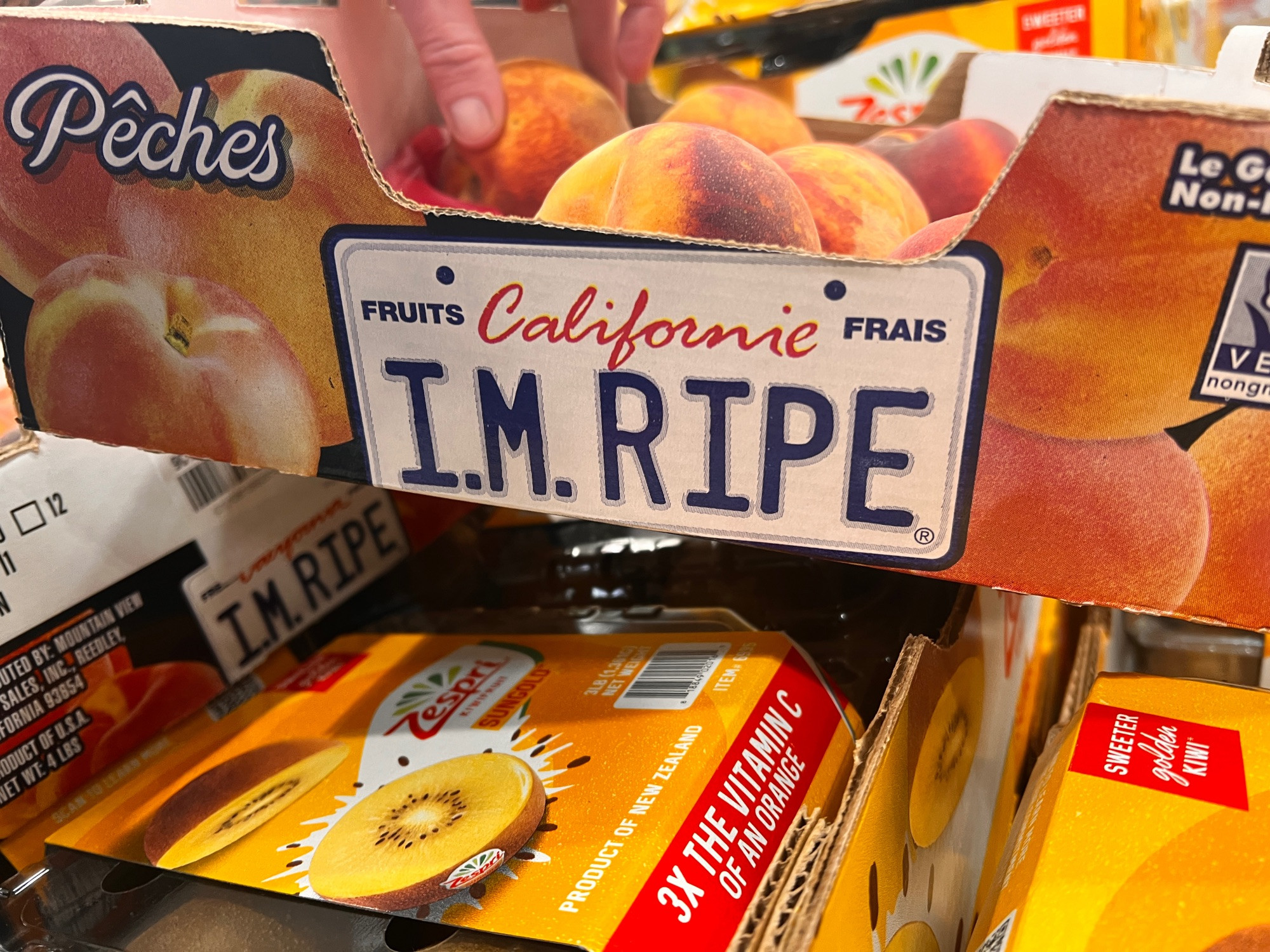 California license plate says “I’m ripe” on a box of peaches