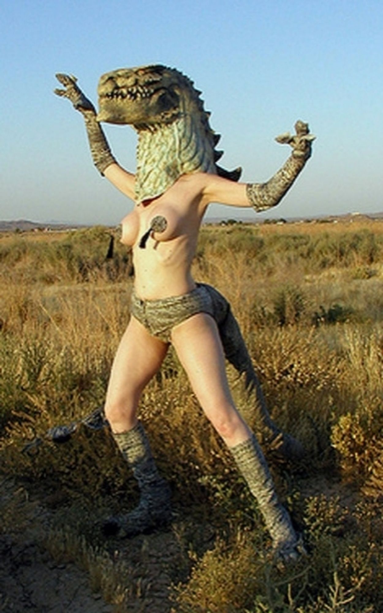 A lady in a lizard mask and boobie tassles