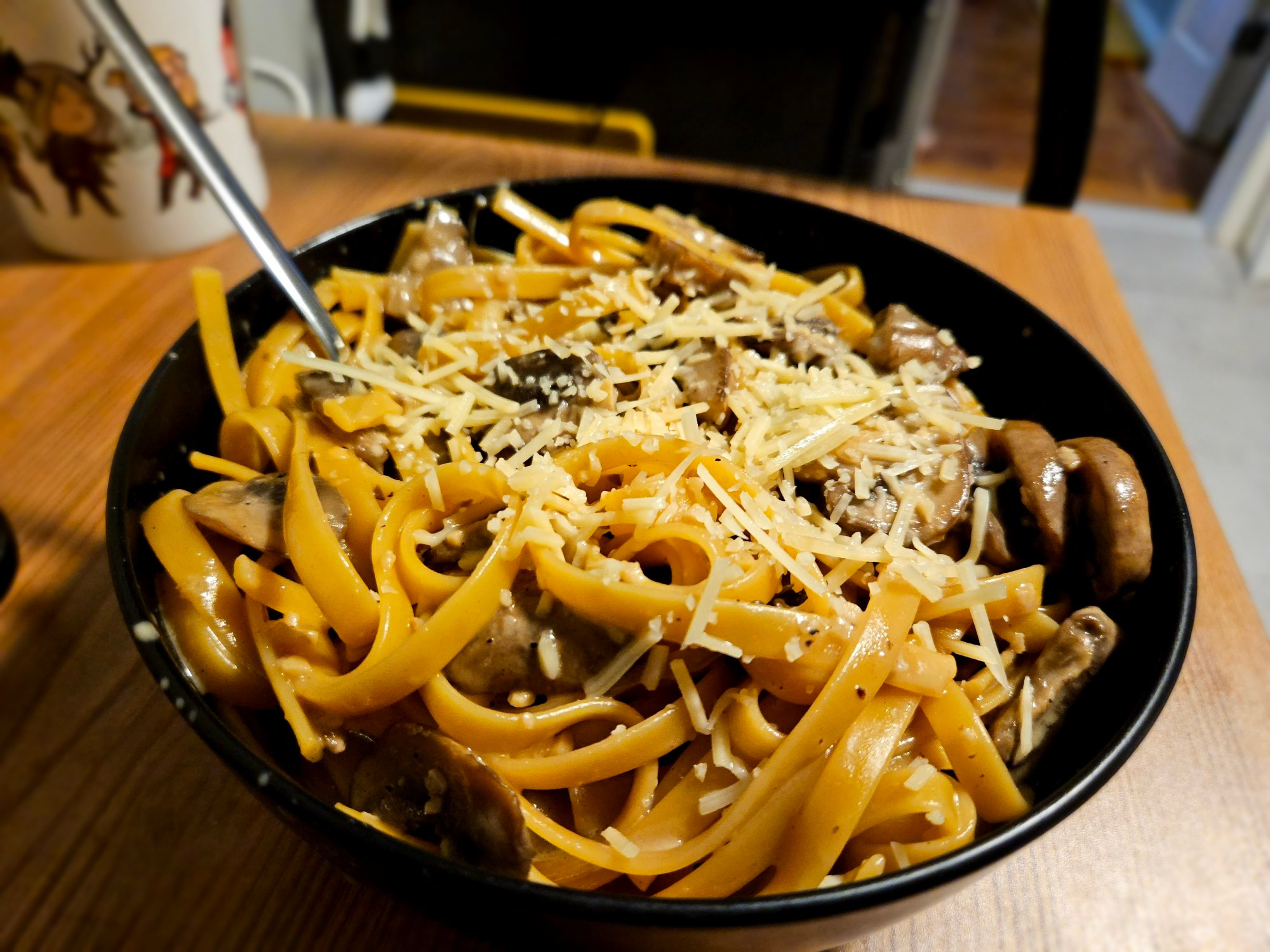 A bowl of creamy mushroom parmesan fettuccine