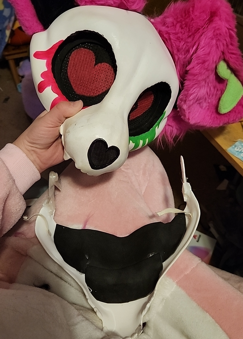 A dismantled skulldog fursuit head in a state of repair