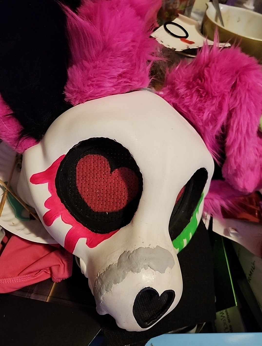 A dismantled skulldog fursuit head in a state of repair