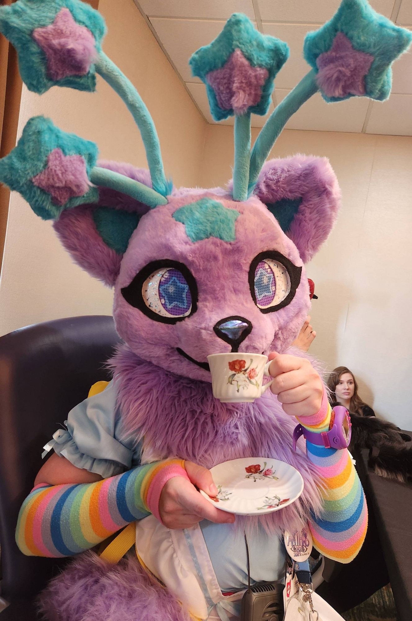 Nova Skystar fursuiter posing with a tea cup and saucer