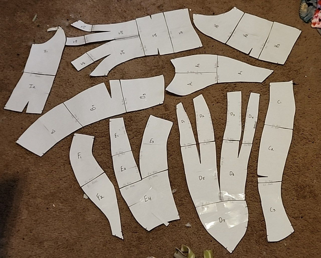 A bunch of paper pattern pieces for fursuit making on the floor