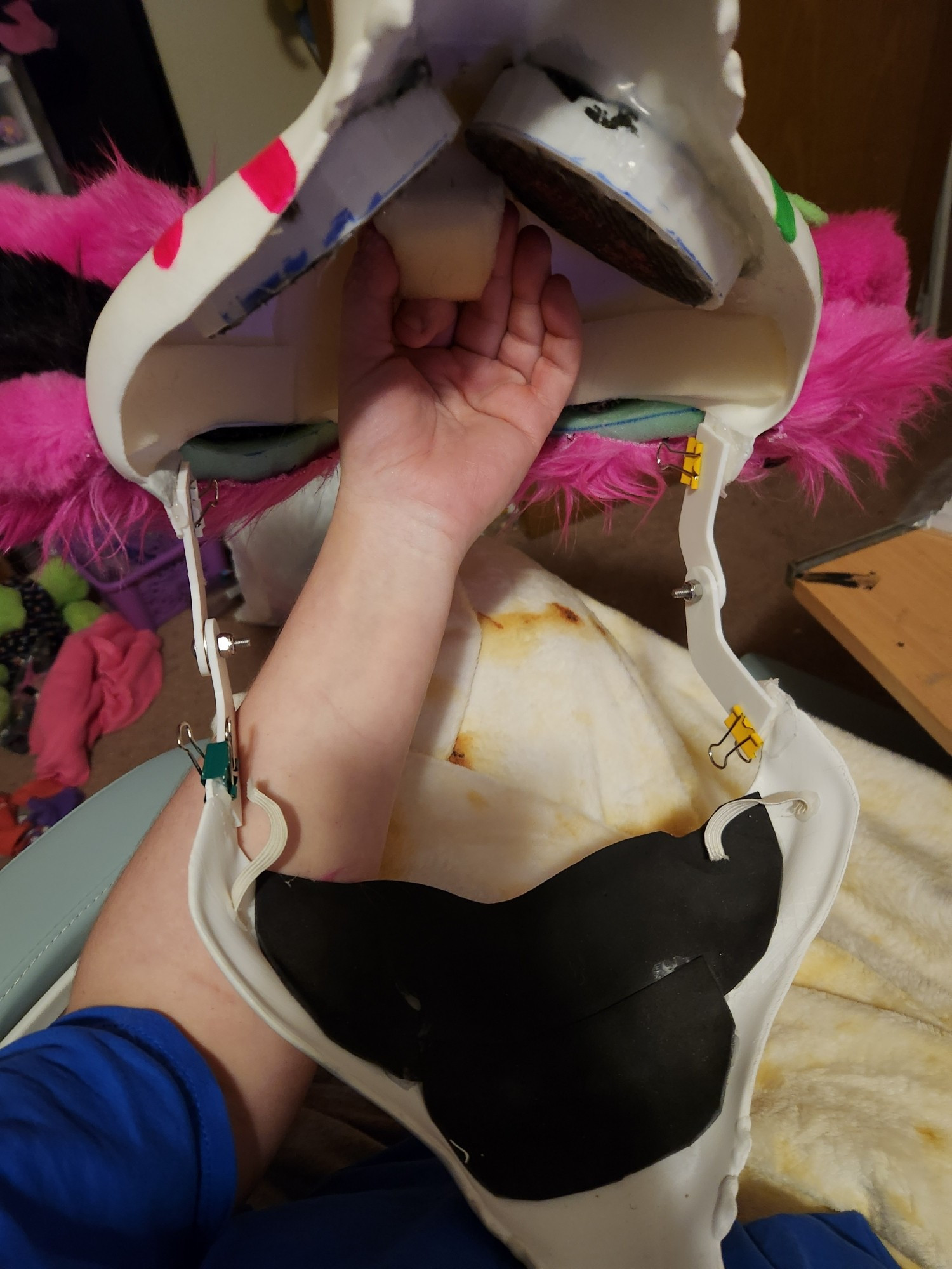 A skulldog fursuit in a state of repair