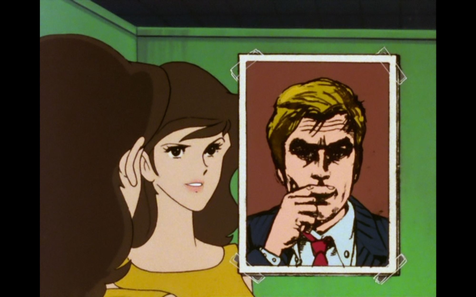 Screencapture of Lupin the Third part 2, episode 103, produced by TMS. It shows Fujiko Mine looking at a picture of French actor Alain Delon, taped on her mirror