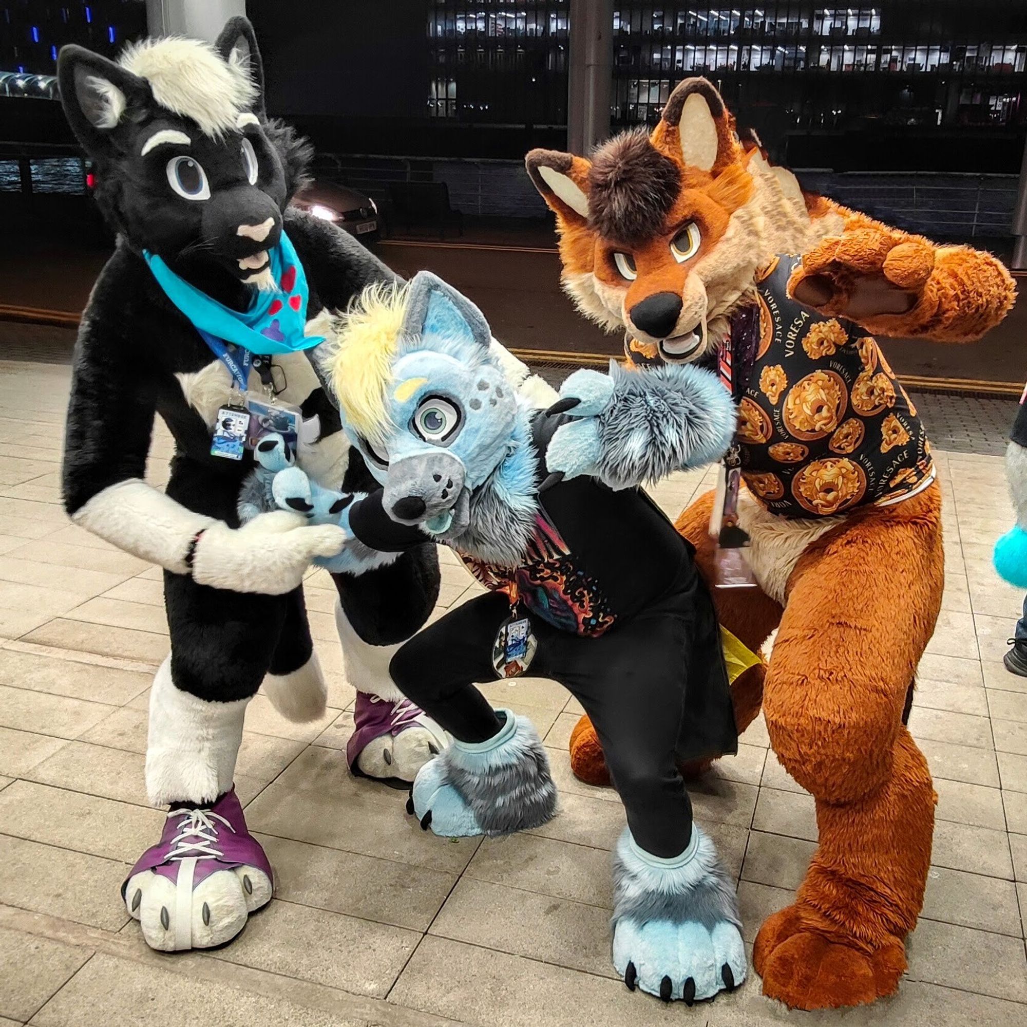 Cute fluffy fursuiters! Flux the cat, Dolby the Hyena and Rusti the Dhole, posing like they're about to drop the hottest album of the year.