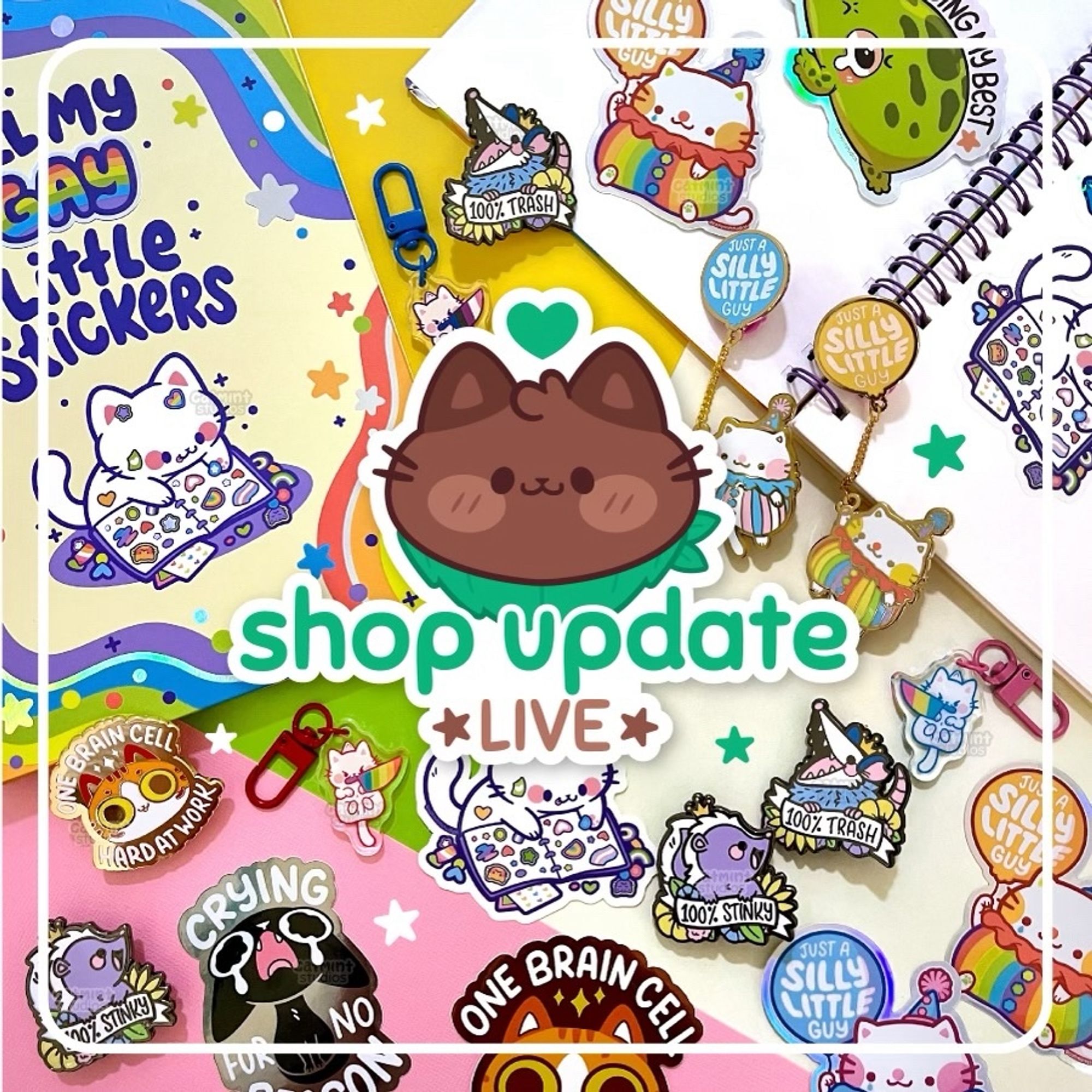 A graphic showing various Catmint Studios products to promote our shop update. Items include a sticker book, stickers, enamel pins, and keychains. In the center of the graphic is an illustration of our brown cat Chip with a green heart above his head. Underneath his face are the words “shop update LIVE”