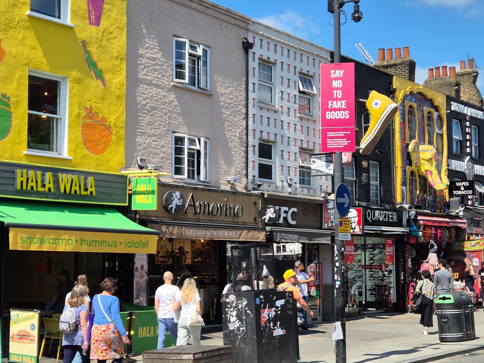 Walking up to Camden Lock. Street looking very good with fancy decorated and ornamental  brickwork above ahops