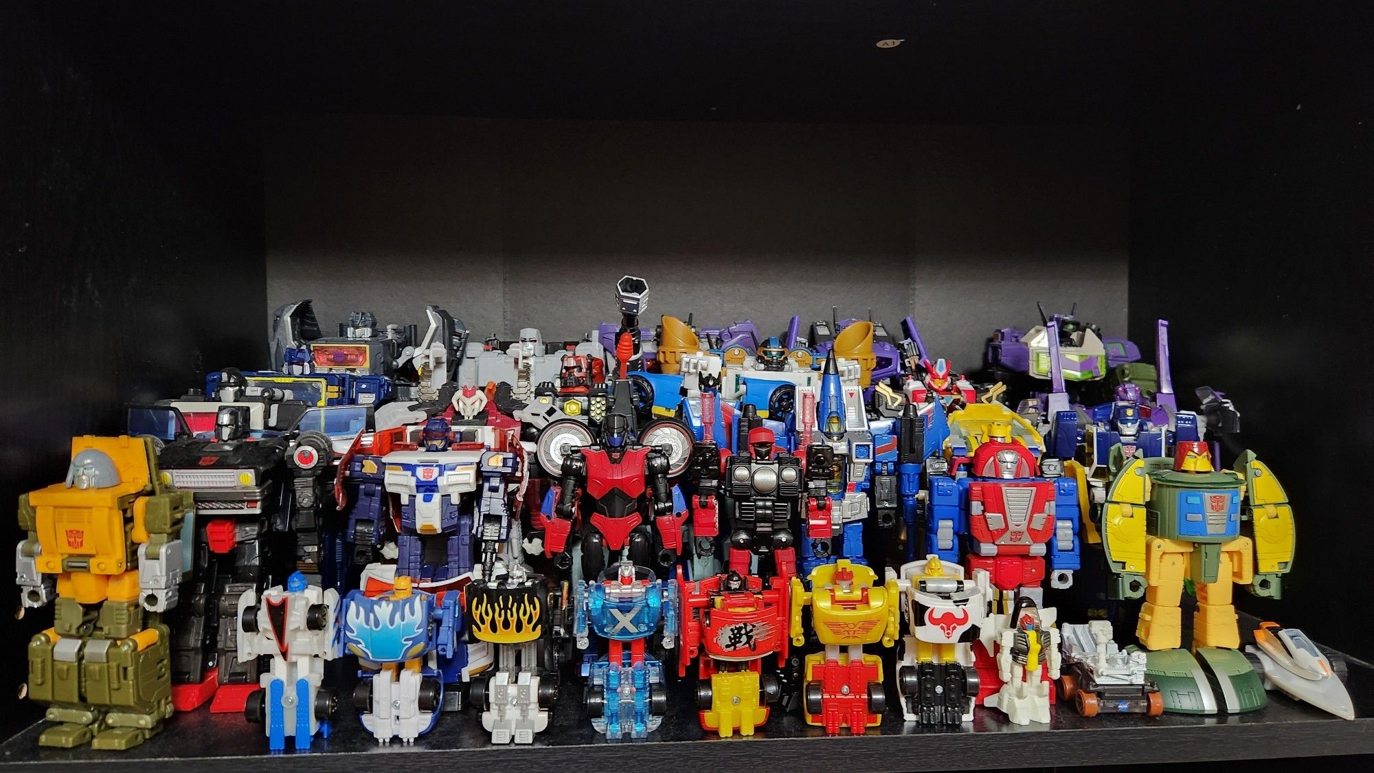 A shelf full of Transformers