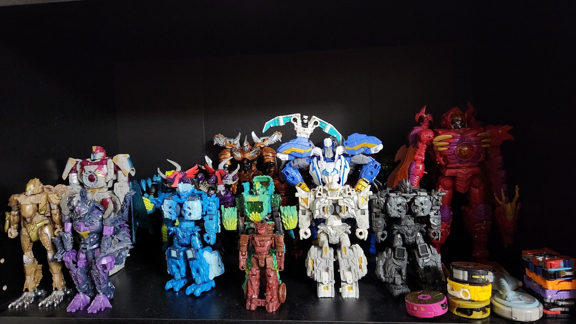 A shelf filled with miscellaneous Transformers