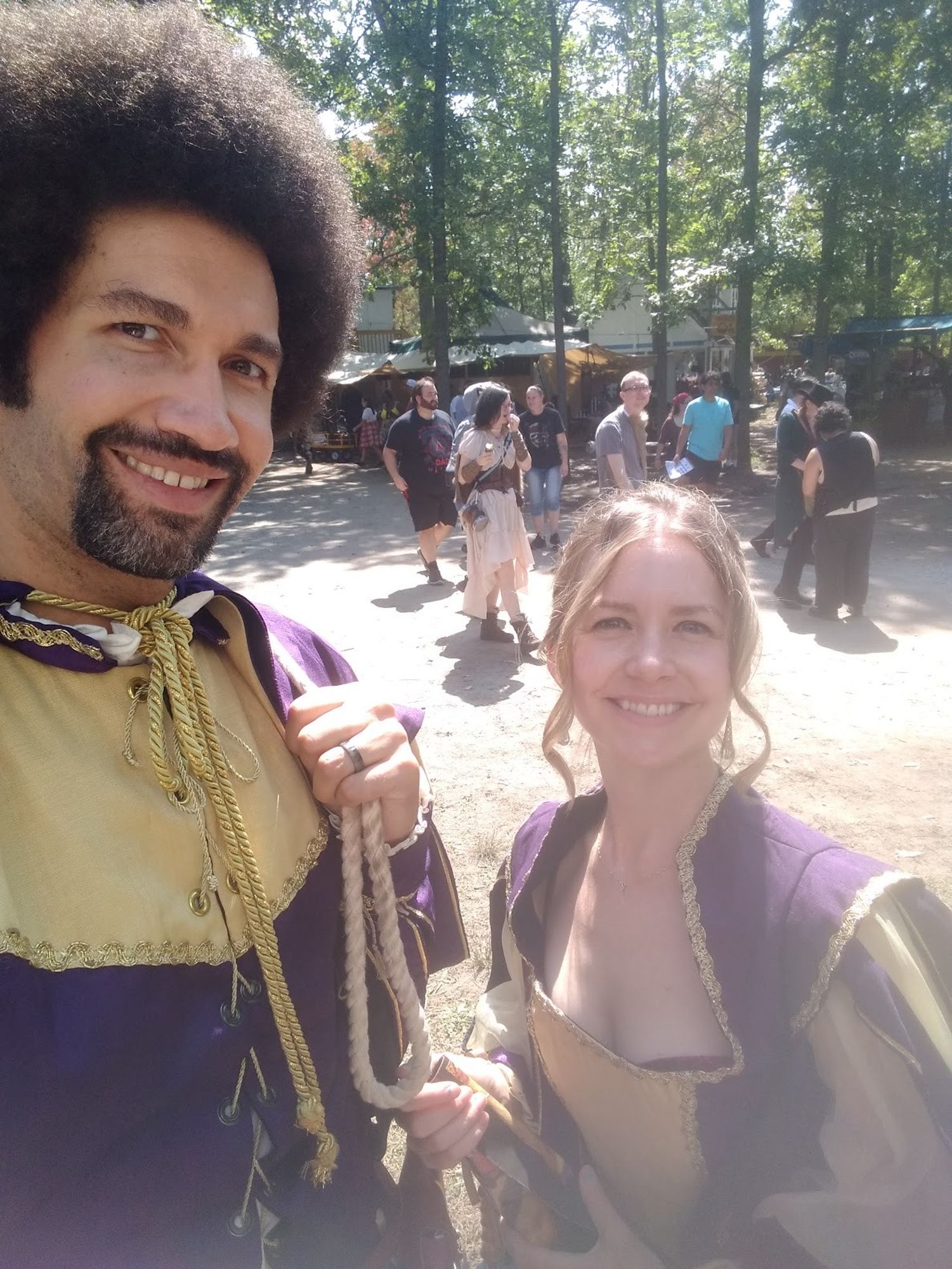 Jen Pullen and her husband in matching purple renaissance faire outfits. Close shot.