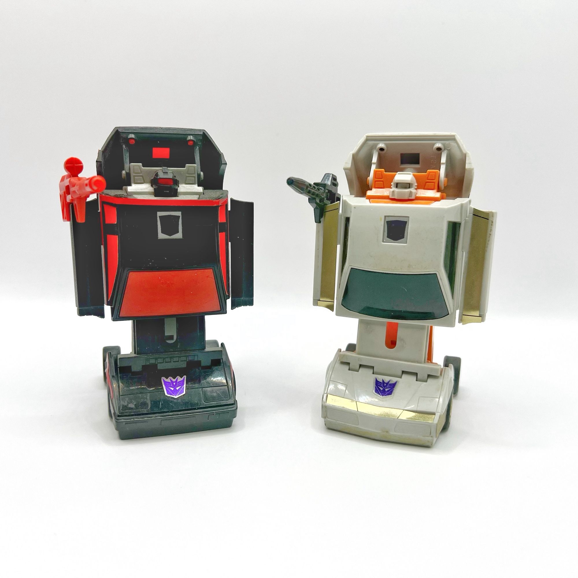 From left to right are G1 Transformers Runabout and Runamuck in their robot modes