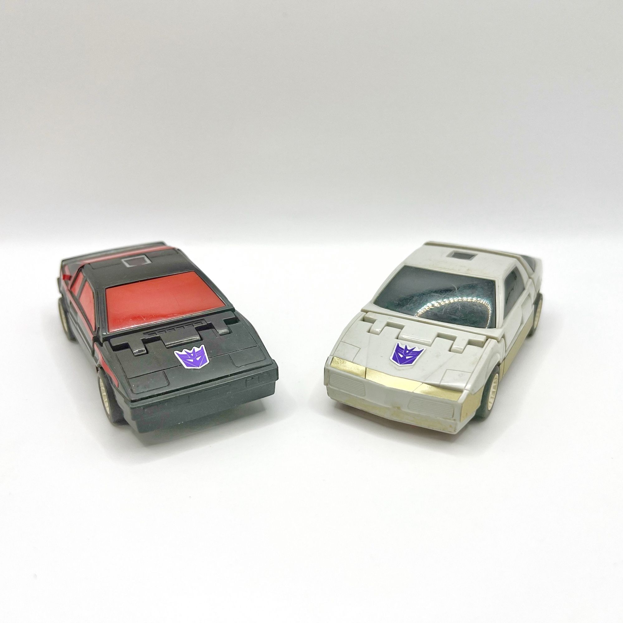 From left to right are G1 Transformers Runabout and Runamuck in their car modes