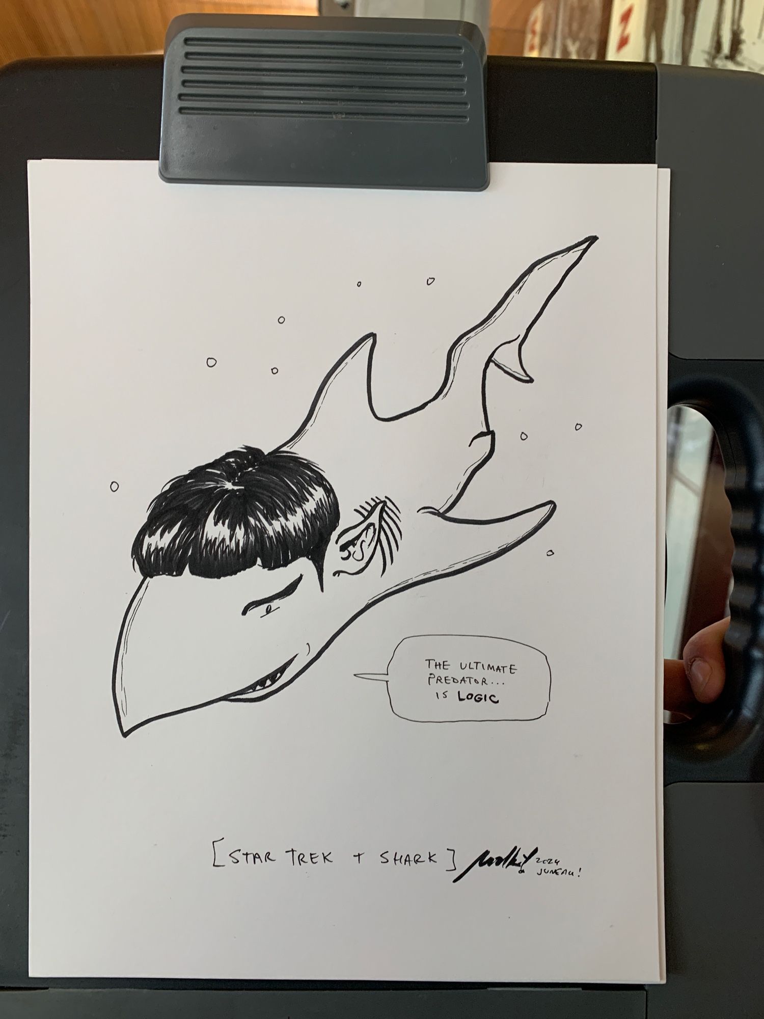 Drawing of a shark with Spock's head and ears. A word balloon indicates he is saying his famous catchphrase, "the ultimate predator is LOGIC"