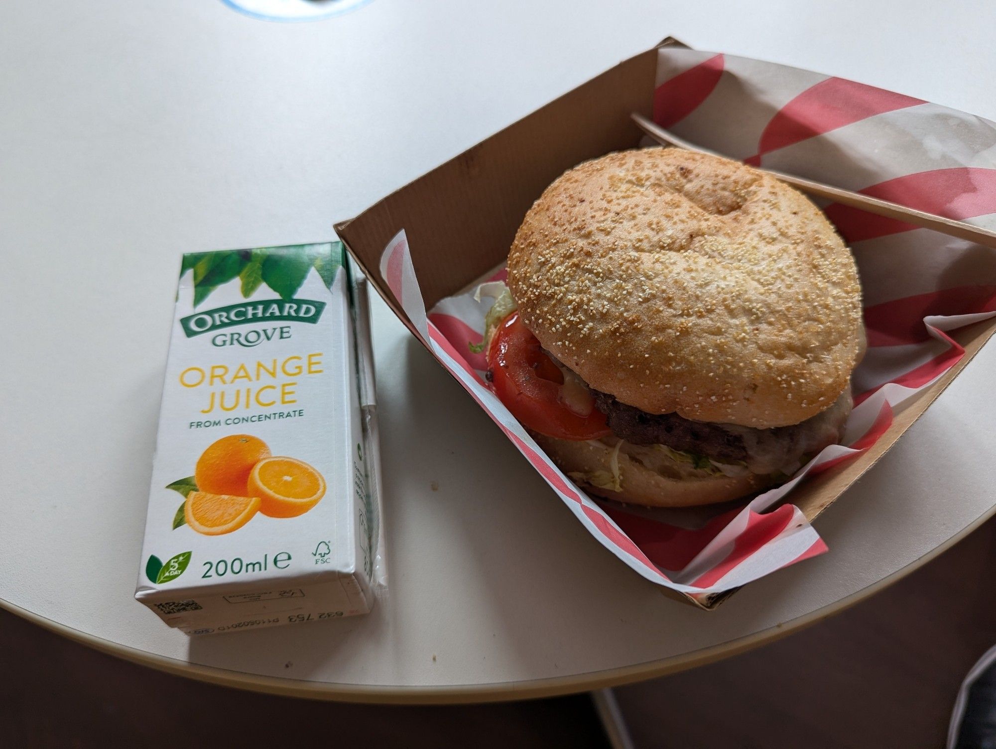 Picture of a hamburger and a small box of orange juice