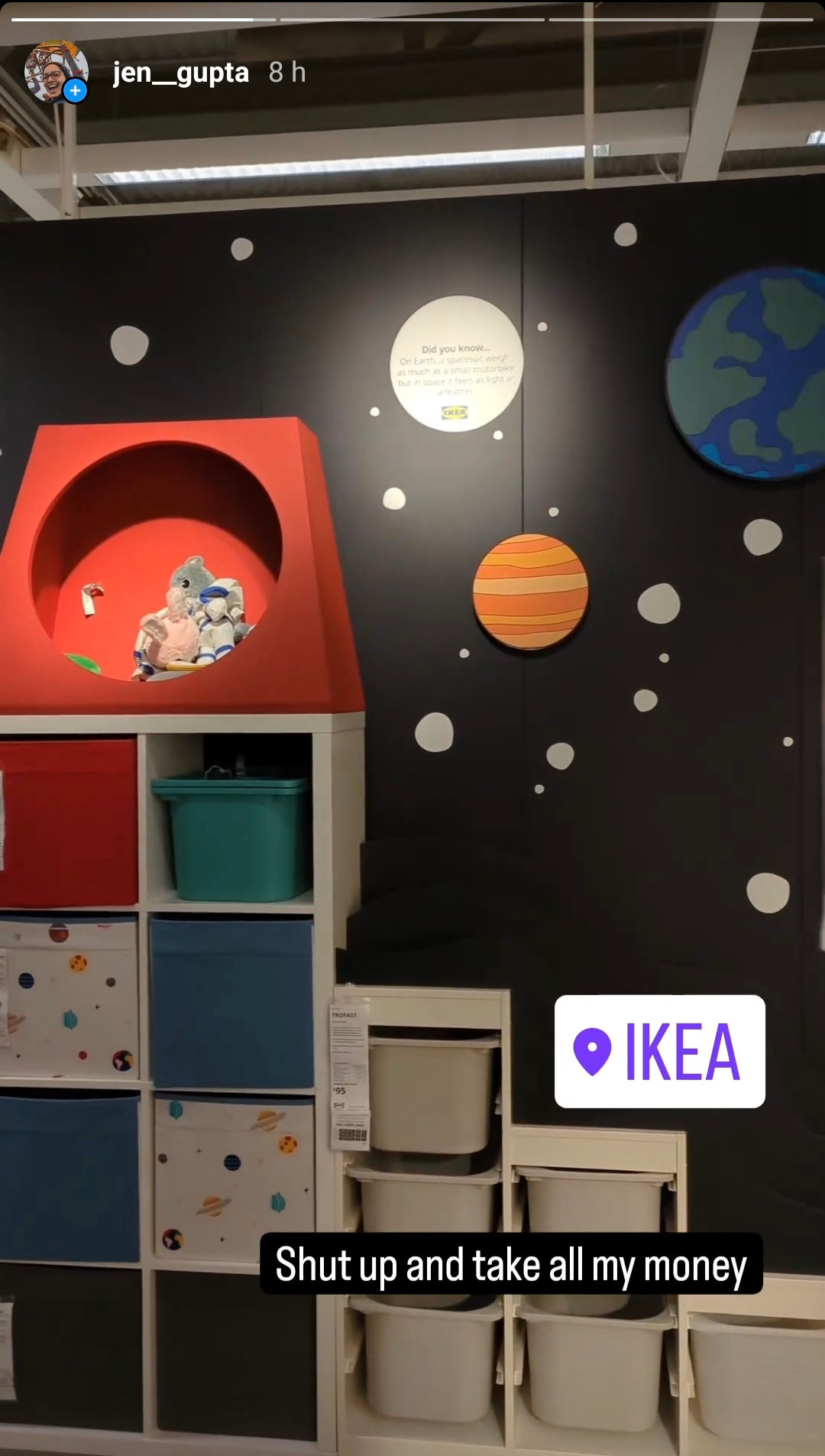 A screenshot from my Instagram stories showing IKEA furniture on display in a shop with a space background painted on the wall behind. There's a range of boxes on the furniture unit including white ones with a space print on them, and the top of the unit has been made to look like a rocket.